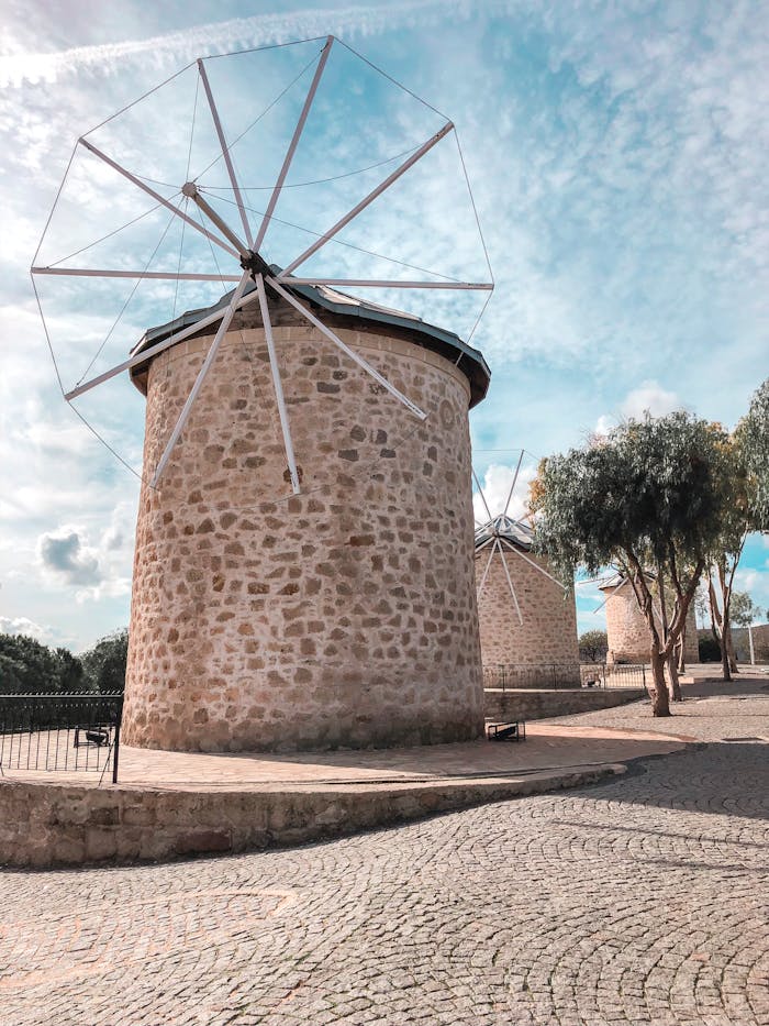 Mastering the First Impression: Your intriguing post title goes here Scenic view of traditional stone windmills in Çeşme, Turkey under a bright sky.